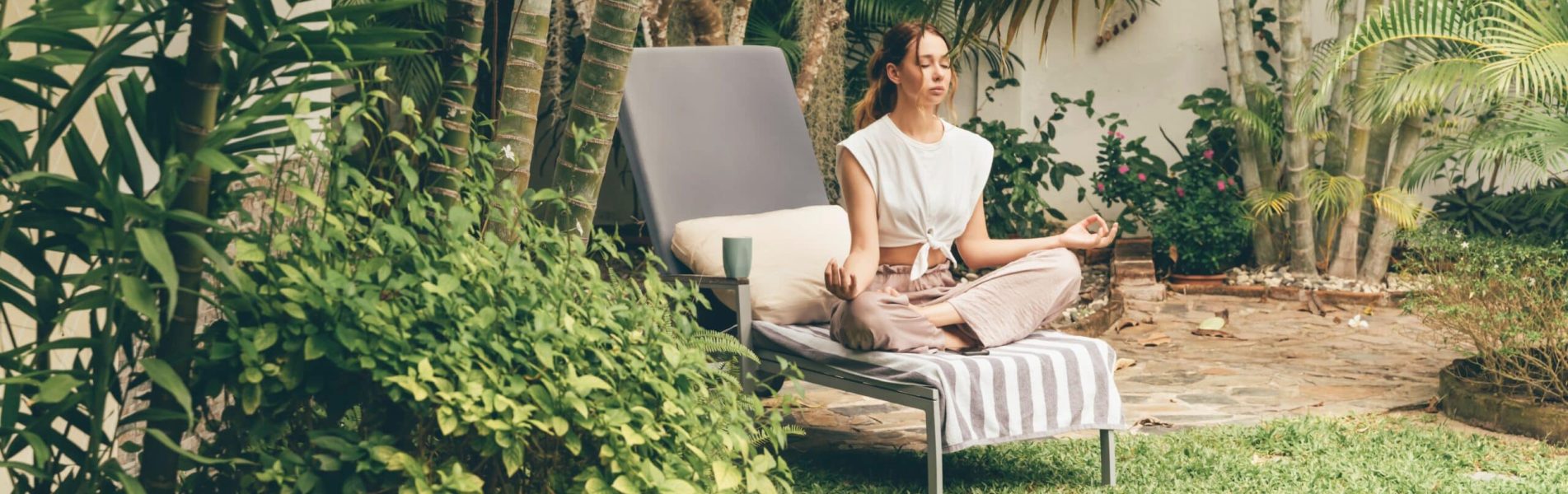 Young,Woman,Relaxes,On,A,Sun,Lounger,In,The,Garden.